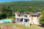 This stunning property boasts a luxurious outdoor space, complete with a sparkling pool and a spacious wooden deck, perfect for entertaining or relaxing.