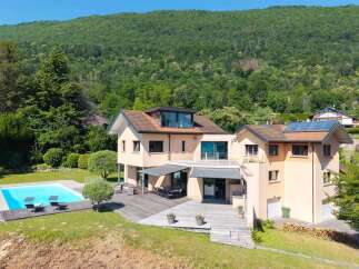 This stunning property boasts a luxurious outdoor space, complete with a sparkling pool and a spacious wooden deck, perfect for entertaining or relaxing.