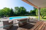 Enjoy luxurious outdoor living with this stunning property featuring a private pool and a spacious wooden deck.
