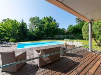 Enjoy luxurious outdoor living with this stunning property featuring a private pool and a spacious wooden deck.