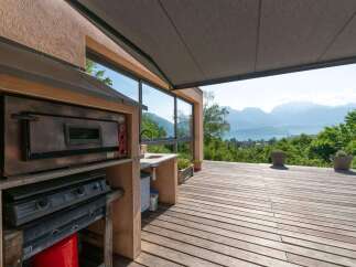 Enjoy breathtaking views from this stunning outdoor kitchen! Featuring a pizza oven, cooktop, and sink, this space is perfect for entertaining.