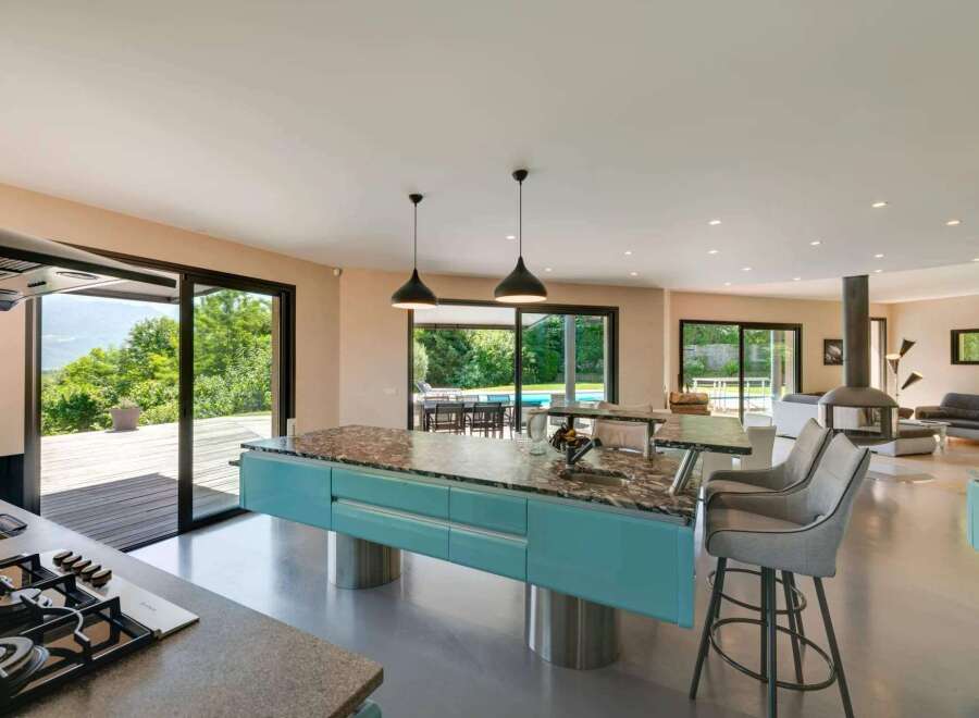 Experience luxury living in this stunning property, featuring a modern kitchen with a stylish island and sleek appliances.