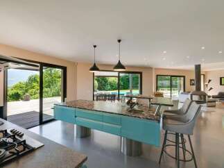 Experience luxury living in this stunning property, featuring a modern kitchen with a stylish island and sleek appliances.
