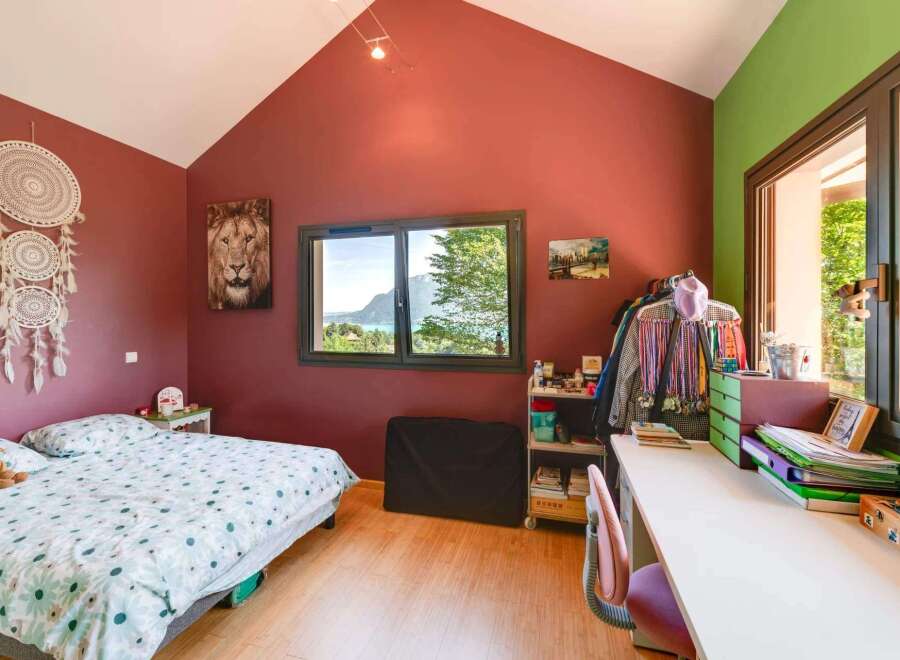 This charming bedroom boasts a cozy atmosphere with its inviting decor and natural light.