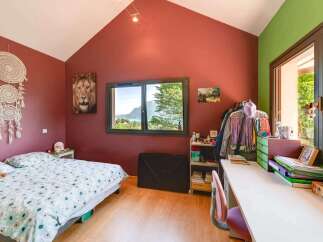 This charming bedroom boasts a cozy atmosphere with its inviting decor and natural light.