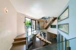 This stunning property boasts a modern architectural design with a grand staircase as its centerpiece.