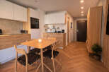 Discover modern living in this stylish apartment featuring a fully equipped kitchen with sleek cabinetry and appliances.