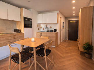 Discover modern living in this stylish apartment featuring a fully equipped kitchen with sleek cabinetry and appliances.