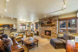 Experience the warmth of this inviting living space, featuring a stunning stone fireplace and cozy seating.