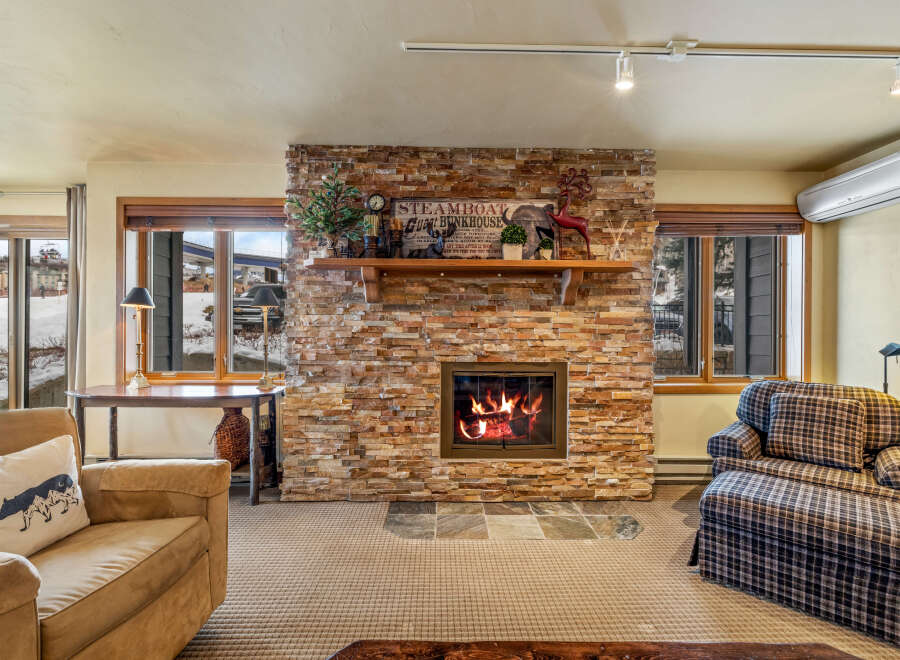 Cozy up by the fireplace in this charming living space! This property boasts a stunning stone fireplace, perfect for those chilly evenings.