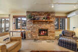 Cozy up by the fireplace in this charming living space! This property boasts a stunning stone fireplace, perfect for those chilly evenings.
