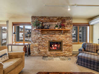Cozy up by the fireplace in this charming living space! This property boasts a stunning stone fireplace, perfect for those chilly evenings.