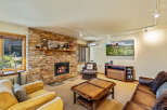 This cozy living room features a stunning stone fireplace, perfect for those chilly evenings.