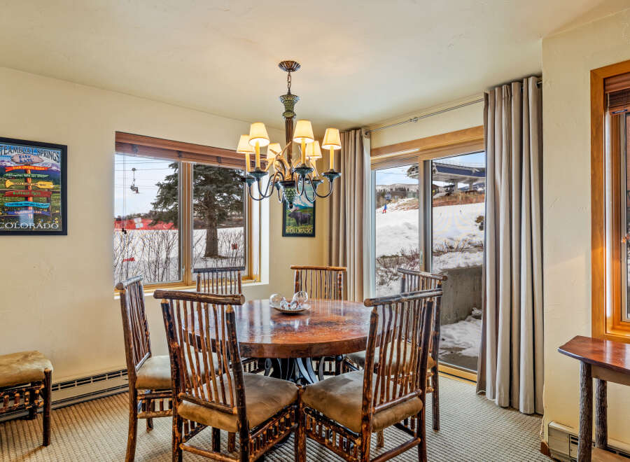 This stunning dining area features a rustic wooden table and chairs, perfect for enjoying meals with family and friends.