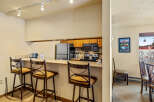This charming kitchen features a breakfast bar with stylish bar stools, perfect for casual dining or entertaining.