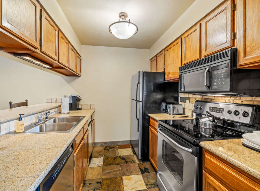 This kitchen features beautiful wooden cabinets, offering ample storage space.