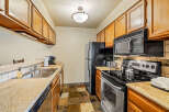 This kitchen features beautiful wooden cabinets, offering ample storage space.