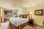 Step into this inviting bedroom, featuring a cozy bed adorned with plush pillows and a rustic wooden frame.