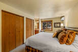 This cozy bedroom features a comfortable bed with decorative pillows, perfect for a relaxing retreat.
