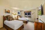 This cozy bedroom features two twin beds, perfect for a comfortable stay.