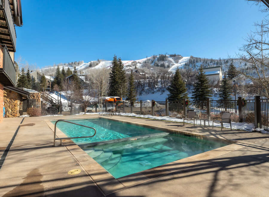 Enjoy the ultimate luxury with this stunning property featuring a heated outdoor pool, perfect for year-round enjoyment.