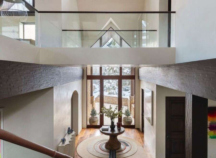 Step into luxury with this stunning entryway, showcasing a grand staircase and soaring ceilings.