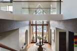 Step into luxury with this stunning entryway, showcasing a grand staircase and soaring ceilings.