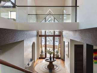 Step into luxury with this stunning entryway, showcasing a grand staircase and soaring ceilings.