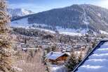 Nestled in a picturesque winter wonderland, this stunning property offers breathtaking views of snow-capped mountains and a charming village.