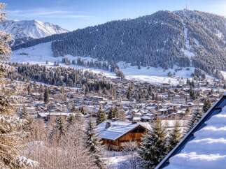 Nestled in a picturesque winter wonderland, this stunning property offers breathtaking views of snow-capped mountains and a charming village.