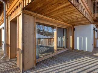 Experience the charm of this stunning wooden balcony, perfect for enjoying the outdoors.