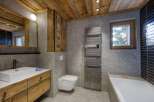 This stunning bathroom features a rustic design with wooden accents and modern amenities.