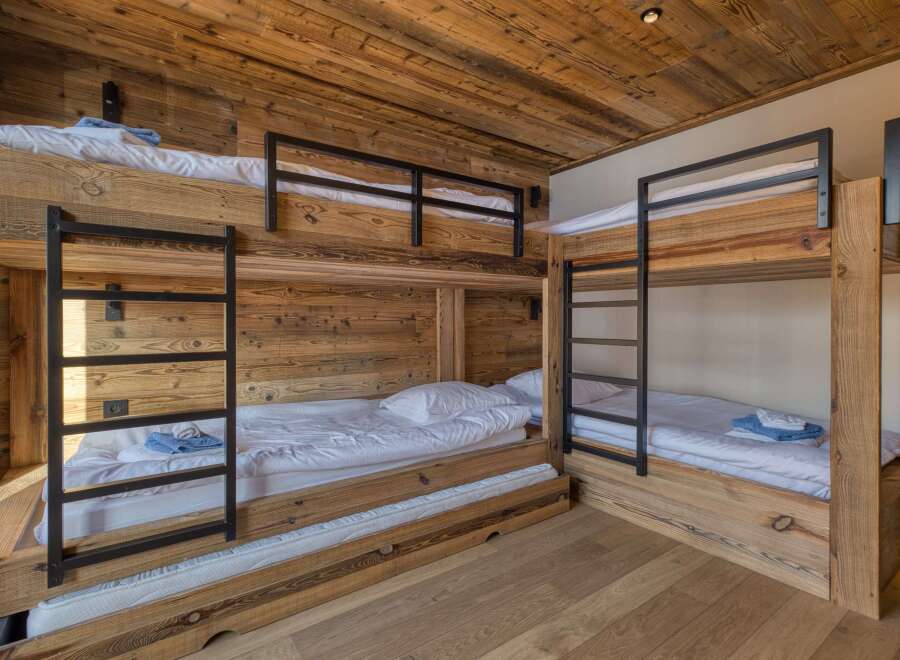 This cozy bedroom features custom-built bunk beds, perfect for accommodating multiple guests or family members.