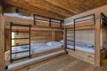 This cozy bedroom features custom-built bunk beds, perfect for accommodating multiple guests or family members.