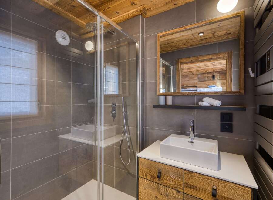 Step into luxury with this stunning bathroom, featuring a modern shower and a sleek sink.