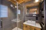 Step into luxury with this stunning bathroom, featuring a modern shower and a sleek sink.