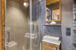 Step into luxury with this stunning bathroom, featuring a sleek glass shower and modern fixtures.