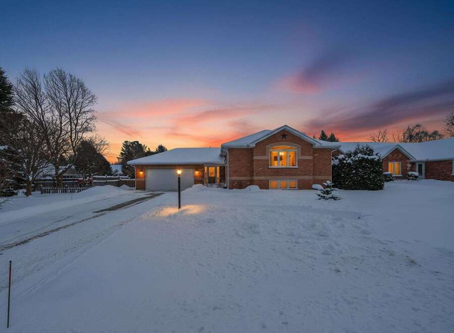 This stunning brick home offers a warm and inviting atmosphere, perfect for cozy winter evenings.
