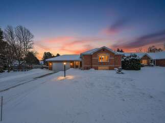 This stunning brick home offers a warm and inviting atmosphere, perfect for cozy winter evenings.