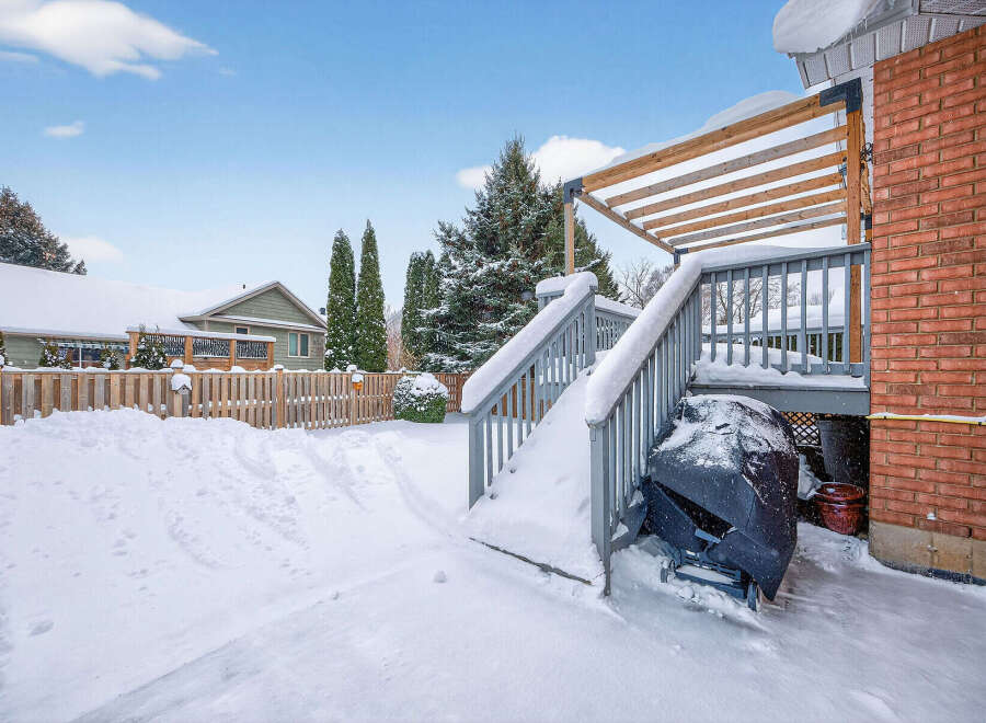 Enjoy the winter wonderland from this charming property! This home features a spacious deck, perfect for enjoying the snowy landscape.