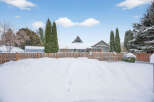 This charming property boasts a serene winter landscape, perfect for those seeking a peaceful retreat.