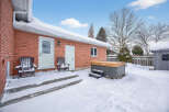 Enjoy the winter wonderland from the comfort of your own backyard! This property features a cozy outdoor space with a hot tub, perfect for relaxing after a long day.