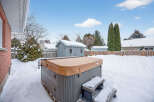 Enjoy the tranquility of this backyard oasis, complete with a hot tub, perfect for relaxing after a long day.