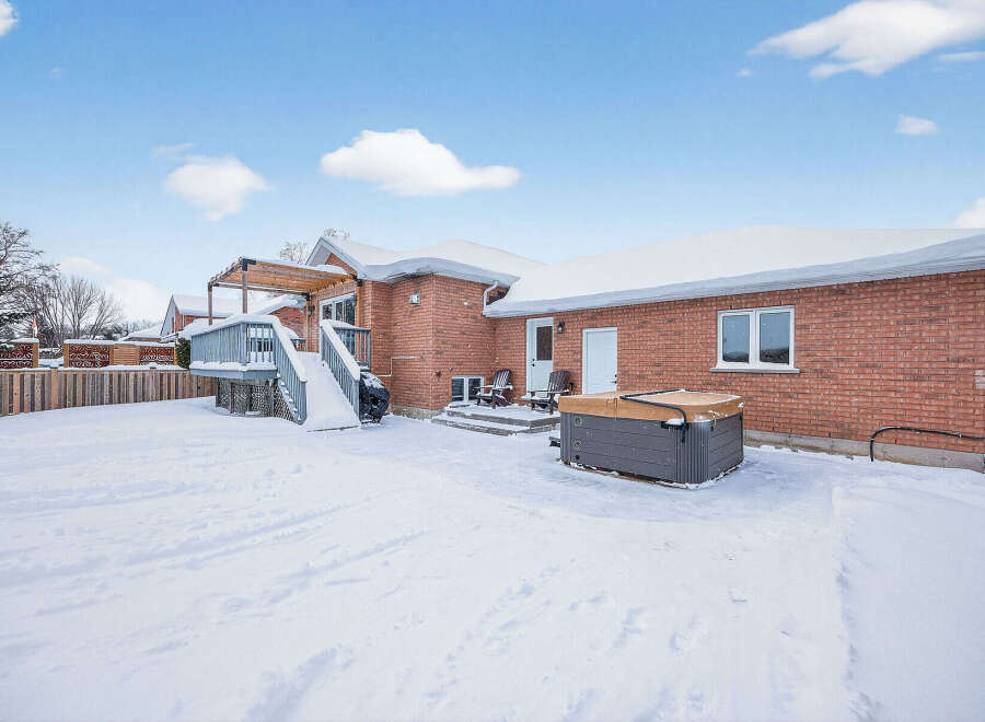 Enjoy the winter wonderland in this beautiful property! This home features a spacious backyard with a hot tub, perfect for relaxing after a long day.