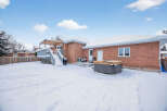Enjoy the winter wonderland in this beautiful property! This home features a spacious backyard with a hot tub, perfect for relaxing after a long day.