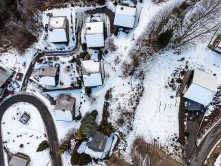 Discover a charming mountain retreat nestled in a serene, snow-covered landscape.