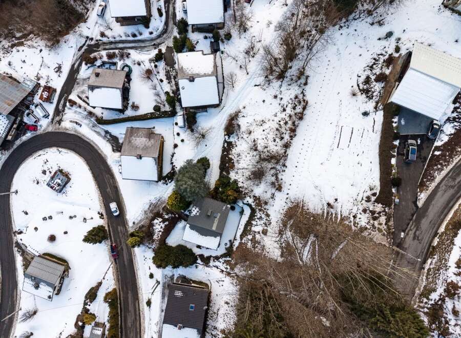 Discover a charming mountain retreat nestled in a serene, snow-covered landscape.