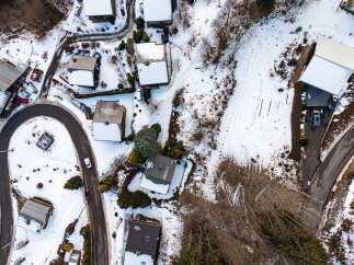Discover a charming mountain retreat nestled in a serene, snow-covered landscape.