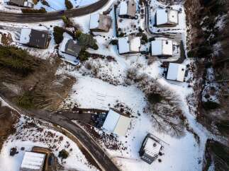 Discover a charming mountain retreat nestled in a serene, snow-covered landscape.