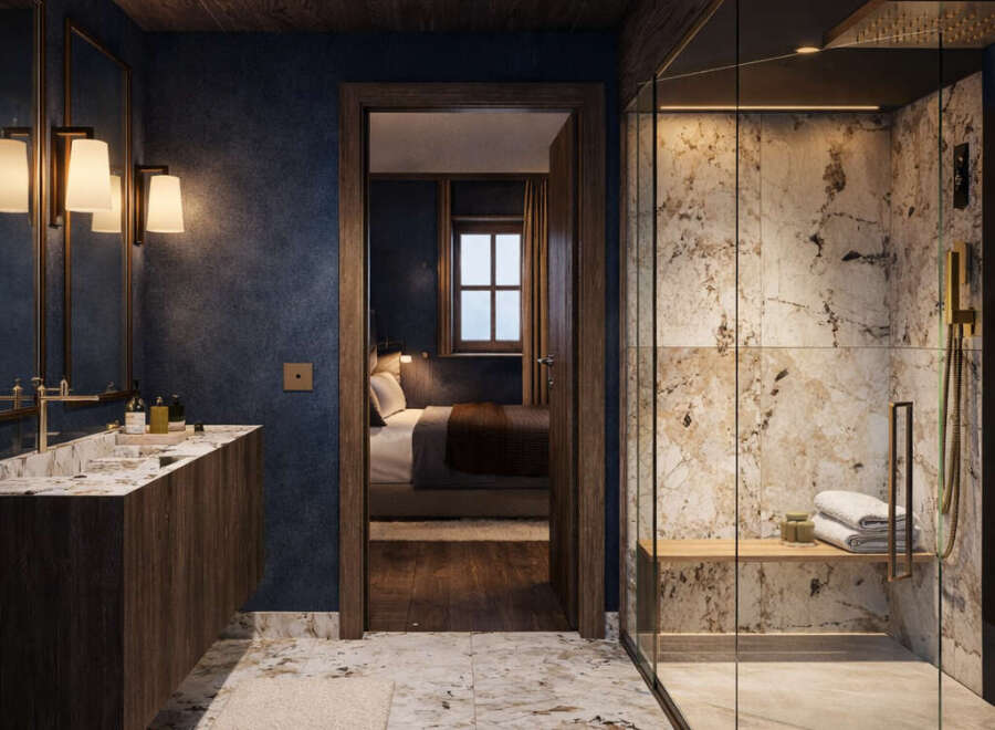 Experience luxury in this master bathroom featuring a spacious walk-in shower with marble tile and a built-in bench.